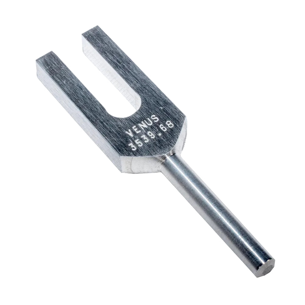 Metal tuning fork with 'Venus' branding on a white background